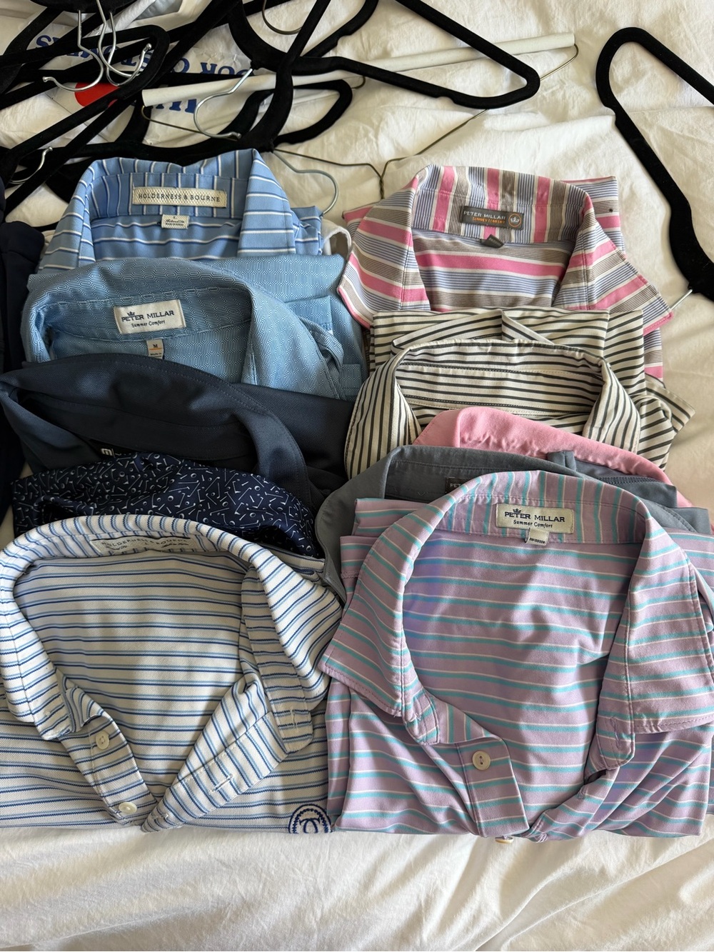 10 golf shirts and two vests ranging in brand new to good condition.